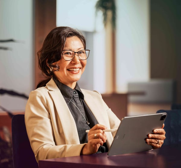 office-woman-tablet-pen-glasses-smiling-looking-ahead-dstny_LR-1