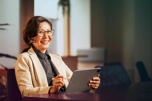 office-woman-tablet-pen-glasses-smiling-looking-ahead-dstny_LR